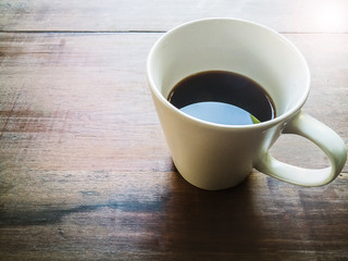 coffee cup on wood table morning time.