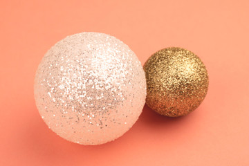 Christmas white and gold balls, coral surface.