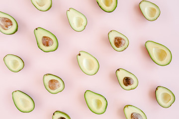 Avocado on pink background. Tropical abstract background with avocado. Food concept. flat lay, top view
