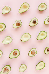 Avocado on pink background. Tropical abstract background with avocado. Food concept. flat lay, top view