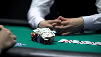 Risky poker player going all-in, betting all chips and money, gambling addiction