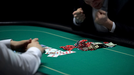 Happy casino player winning chips and money at poker game, fortunate businessman