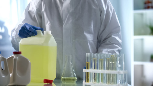 Laboratory worker studying biofuel for presence of sediment and additives