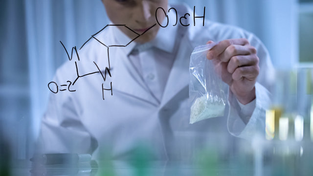 Scientist holds sample of fertilizers invented by his chemical formula, research