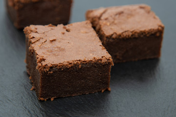 Fototapeta na wymiar Chocolate brownies, on dark background