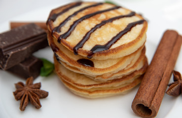Pancakes with chocolate sauce decorated with fresh mint