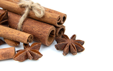 Cinnamon quills tied with rope. With star anise. Spicy set on white background