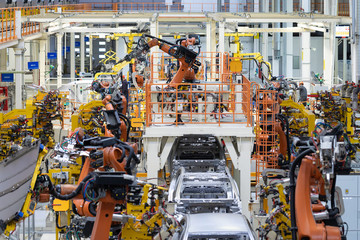 body of car on conveyor Modern Assembly of cars at plant. automated build process of car body
