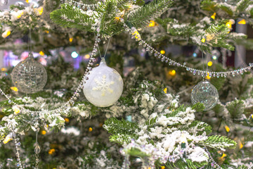 New Year decoration. Christmas decorations. Crystal ball on the Christmas tree. Snow on the...