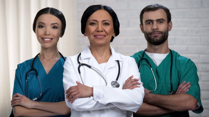 Smiling medical team ready for operations, patient treatment in safe hands