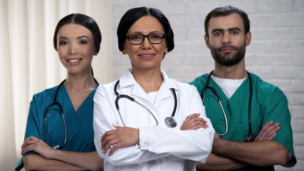 Medical staff smiling at camera, health care system and insurance reform policy