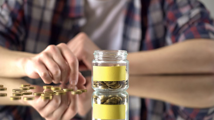 Empty sticker on glass jar with money, savings concept, investment in future