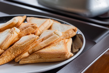 Breakfast Toast Sandwich on white plate in brown plastic tray on wood table