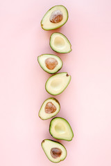 Avocado on pink background. Tropical abstract background with avocado. Food concept. flat lay, top view