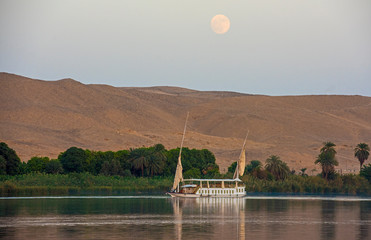 Large egyptian dahabeya river boat sailing on Nile