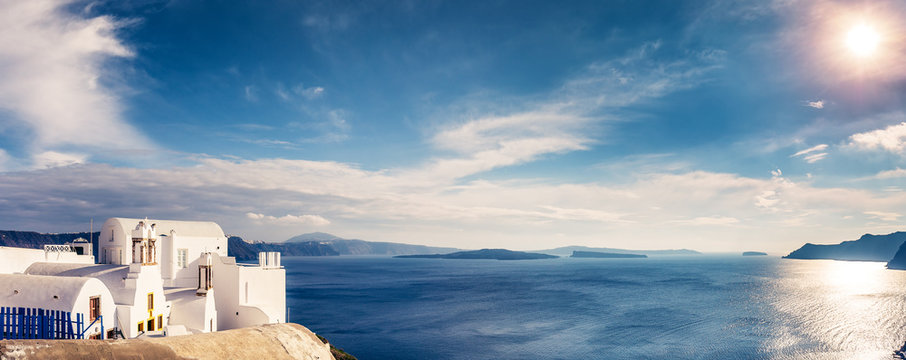 Fototapeta Panorama view of Santorini island in Greece, on a sunny day with beautiful sky. Scenic travel background.