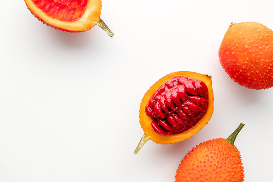 Gac fruit on a white background, creative flat lay food concept