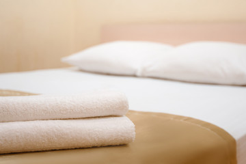 Fototapeta na wymiar Closeup of white towels in hill bed bedroom room
