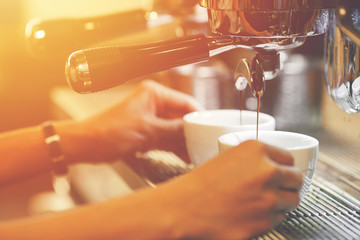 barista making coffee in professional coffee machine