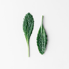 Fresh organic green kale leaves pattern on a white background, flat lay healthy nutrition concept