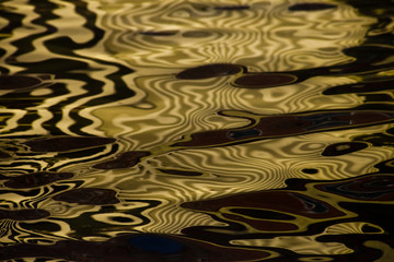 Waves on water create freakish diffractional structures similar to velvet on its surface, yellow ...