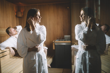 People enjoying sauna health benefits in spa