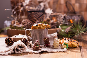 Fragrant coffee, chocolates in the form of Christmas figures. Cookies and hot drink for the holiday. Cozy atmosphere, candles decor. free space for text.