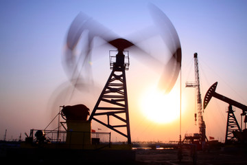 Crank balanced beam pumping unit in Jidong oilfield sunset scenery, closeup of photo