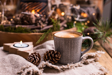 Fresh aromatic coffee and Christmas decor. Cozy festive atmosphere with candles and drinks. Free space for text.