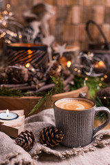 Fresh aromatic coffee and Christmas decor. Cozy festive atmosphere with candles and drinks. Free space for text.