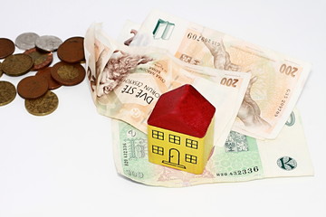 Miniature toy block houses with money representing property purchase