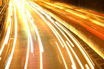 The car light trails on the highway in the night modern city