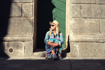 Young attractive cheerful travel girl walking in old city