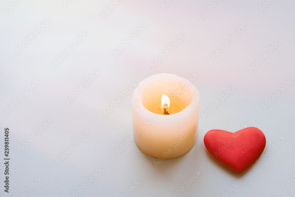 Wall mural burning candle and heart.