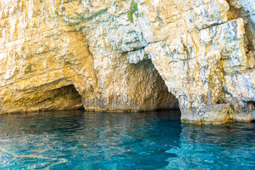 Greece, Zakynthos, Keri caves with perfect blue water and white chalk rock