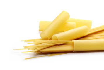 Italian uncooked cannelloni pasta tubes and spaghetti isolated on white background
