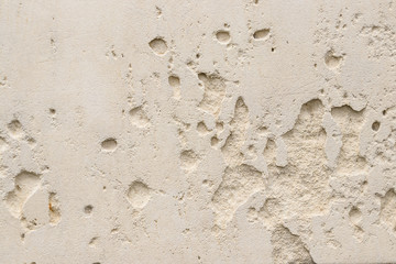 Beige wall with holes. Background or texture for design.