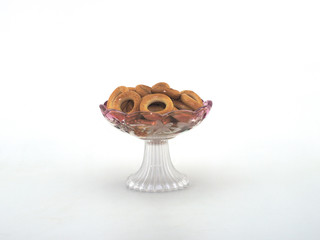 roll glass vase with ruddy donuts on a white background close-up