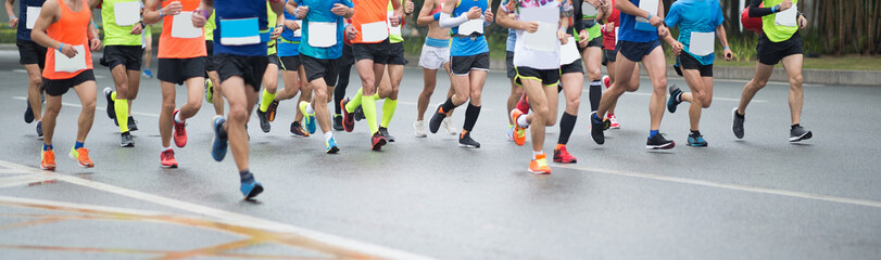 Marathon runners legs running on city road