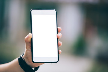 Hand using smartphone in modern city