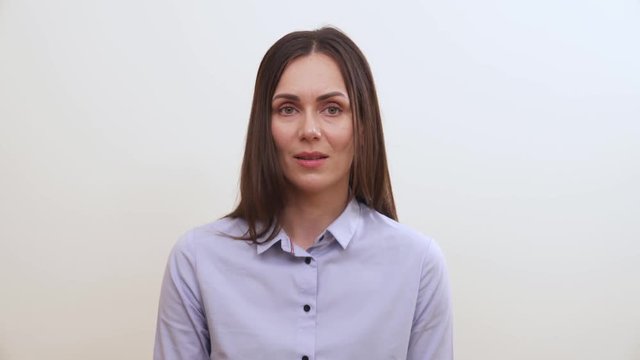 A long-haired brunette is calm, then says something and makes moue to show disrespect or contempt