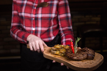 man cutting meat on the barbecue