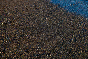 Golden sand, consecrated by the setting sun, by the sea, wet from the ebbing wave.