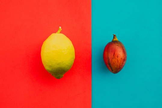 Whole tamarillo and lemon on bright background