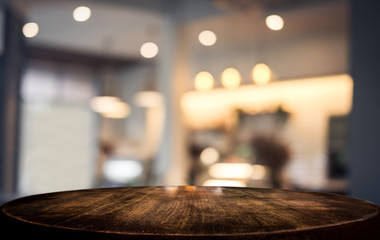 Selective Empty wooden table and blurred background of abstract in front of coffee shop or restaurant for display of product or for montage