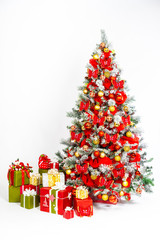 Christmas. New Year. Decorated Christmas tree. Decorations for the holiday Christmas. Jewelry for the new year. Spruce paw. Decorated Christmas tree with red gifts.