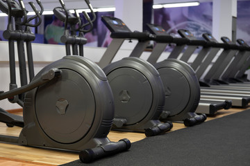 Obraz na płótnie Canvas Modern gym interior with equipment. Fitness club with row of treadmills for fitness cardio training. Healthy lifestyle concept
