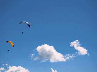 paragliders against the blue sky and mountains