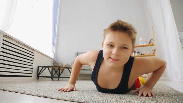 Fat boy doing exercises in the hall
