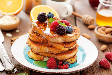 French toasts with fresh berries and honey for breakfast.